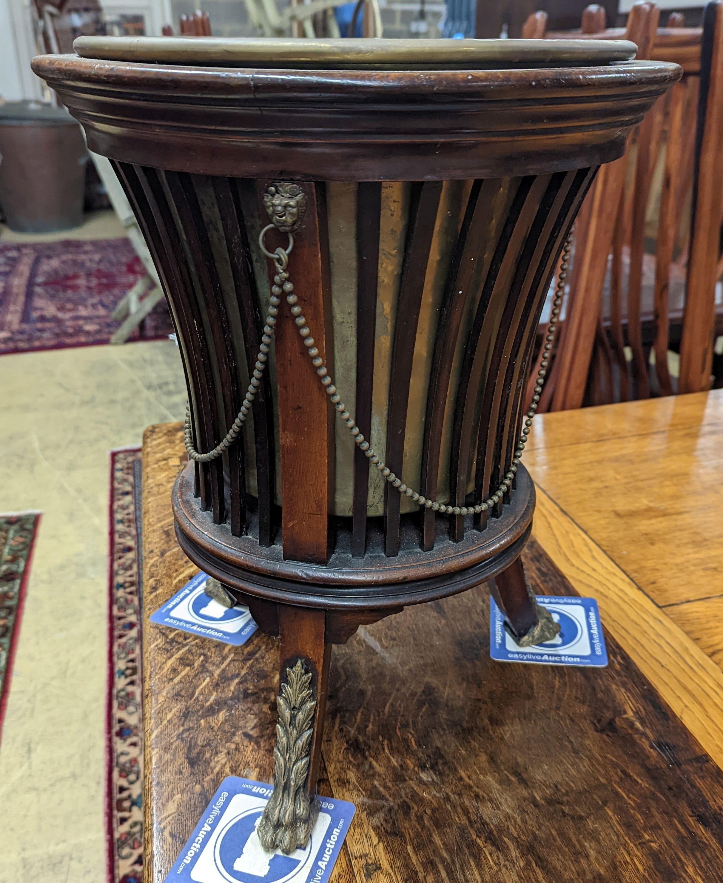 An Edwardian brass mounted mahogany jardiniere with brass liner, diameter 35cm, height 46cm